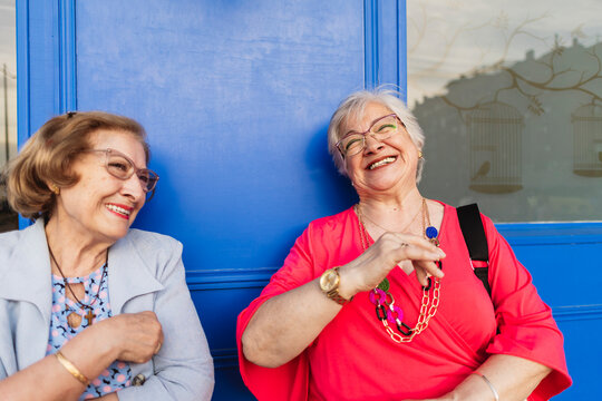 Senior women laughing together sharing happy moment