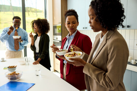 Colleagues Enjoy Food and Conversation in a corporate canteen