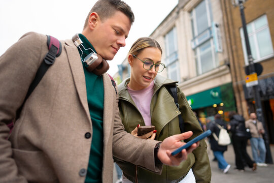 Tourists checking directions on smartphone