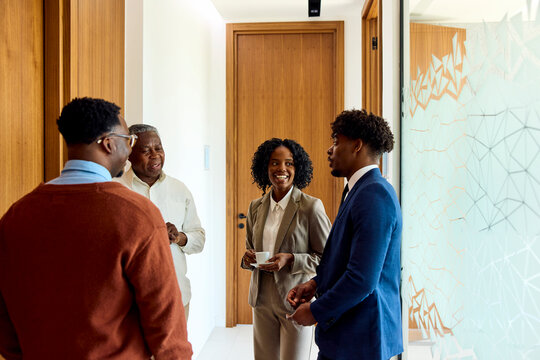 Group of People Talking in an Office Hallway