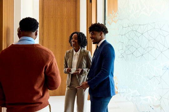 Businesspeople enjoy their conversation in the hallway