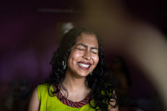 Young Indian woman close up portait at indoors behind the window 