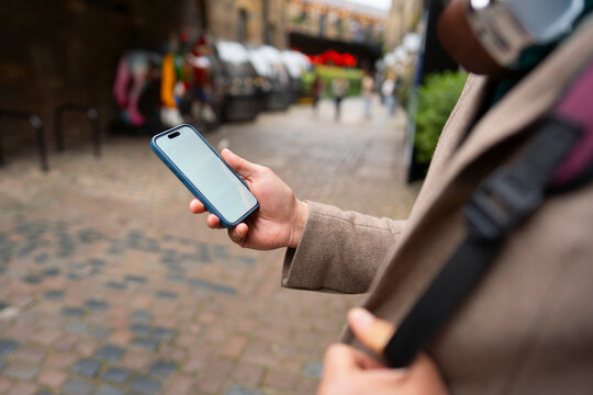 Close up of man using smartphone outdoors