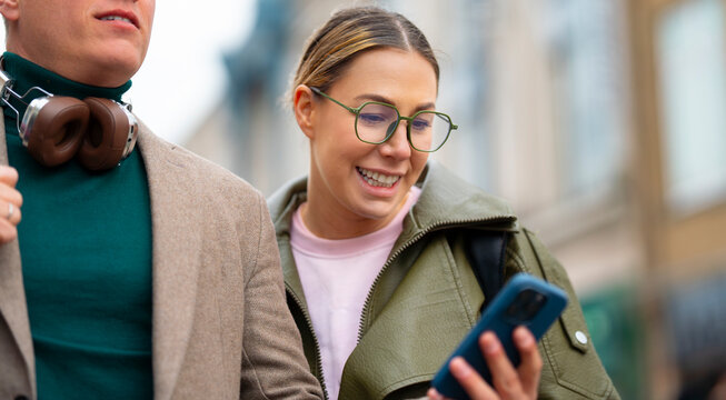 Happy tourists checking directions on smartphone