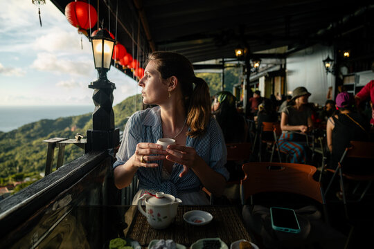 Woman enjoying tea in Jiufen teahouse