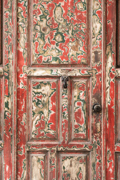 Weathered vintage wooden door with peeling paint