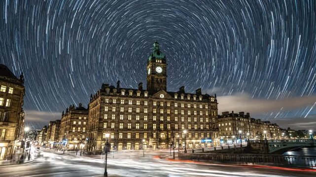 Timelapse of Balmoral Hotel at night with moving clouds and traffic in Edinburgh