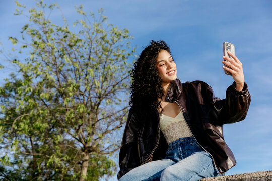 Woman taking selfie outdoors 