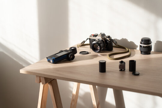 Minimal still life with analog camera and geometric sunlight shadows