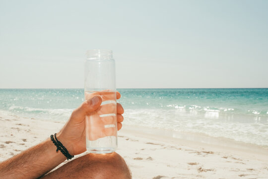 Reusable water bottle at beach 