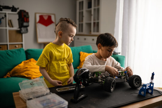Boys repairing rc car learning engineering skills together