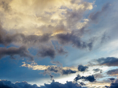 Dramatic Cumulus Clouds in Blue Sky at Golden Hour