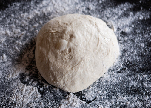 Dough Rests on Flour Surface in a Kitchen for Baking Bread
