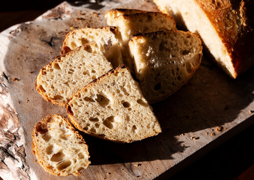Freshly Sliced Bread on a Wooden Board During Afternoon