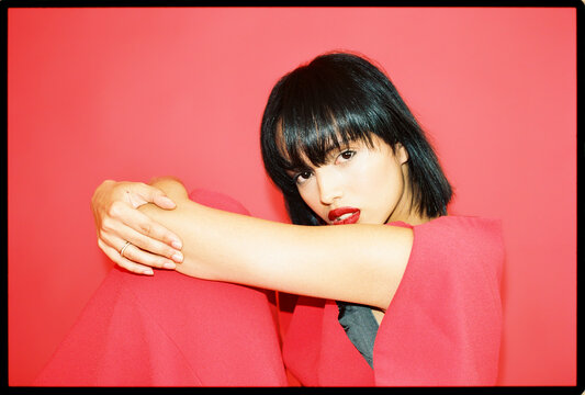 Fashionable woman posing bold in red