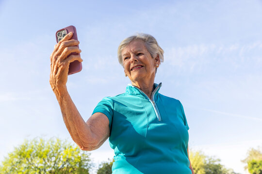 Senior woman selfie Portrait cell phone sky blue