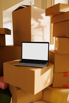 Laptop mockup with white screen on moving boxes