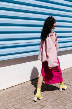Woman walking in colorful street fashion