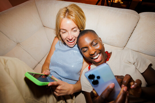 Women enjoying social media content on smartphone
