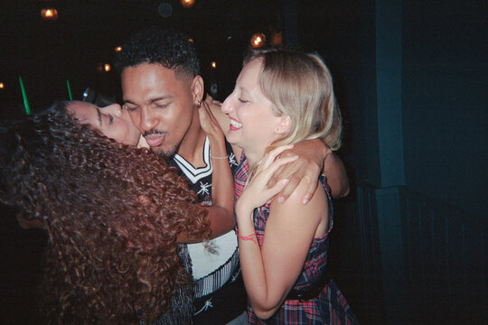 Best friends hugging in party at nightclub. Film. UGC