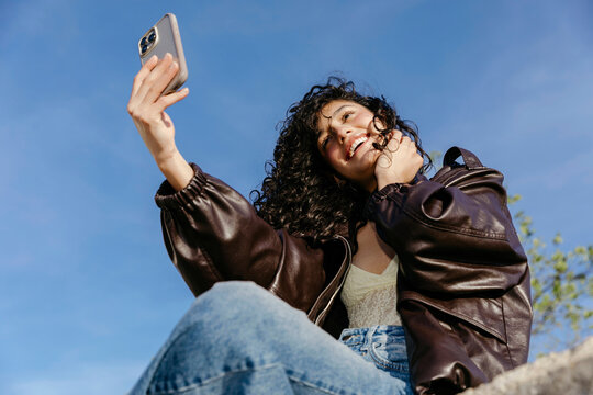 Woman smiling taking selfie 