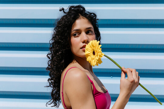 Woman holding yellow gerbera daisy