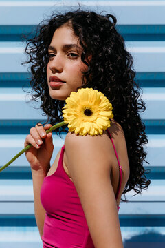 Woman holding yellow gerbera