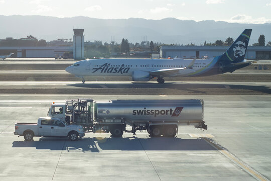 San Jose, CA, USA - Nov 28, 2023: A Boeing 737-9 Max airliner operated by Alaska Airlines and a Swissport aviation fuel tanker truck on the tarmac at Norman Y. Mineta San Jose International Airport.