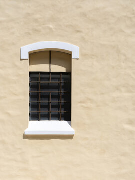 Minimal window on pastel stucco wall