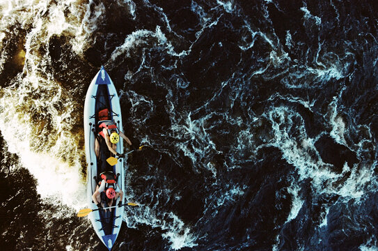 Kayakers navigate the river in bright sunlight