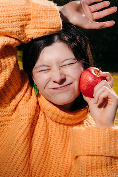 Young woman holding an apple colorful portrait.