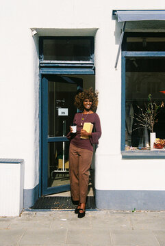 Woman Smiling Outside Shop with Coffee Film Photo