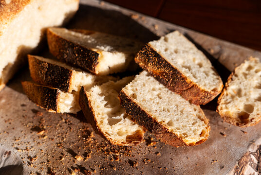 Freshly Sliced Bread on a Wooden Board During Afternoon