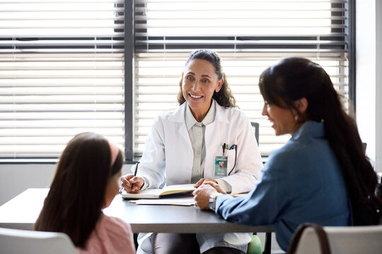Doctor Meets Patient and Parent in Hospital Office
