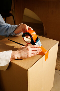 Woman Entrepreneur Prepares Delivery box in Small Business Office
