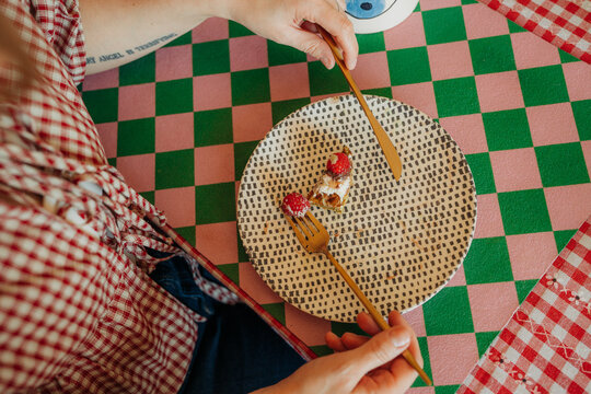 Almost empty plate with waffle bite and raspberries