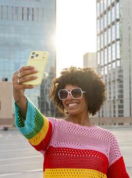 Black smile woman selfie city downtown cell phone 