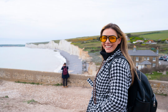 Smiling traveler visiting Seven Sisters Cliffs in England