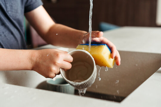 Washing the Dishes in a Cozy Kitchen on a Sunny Afternoon