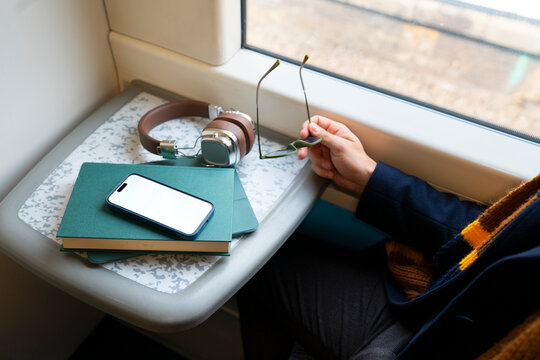 Passenger relaxing with smartphone during train commute