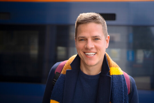 Smiling commuter portrait at railway station