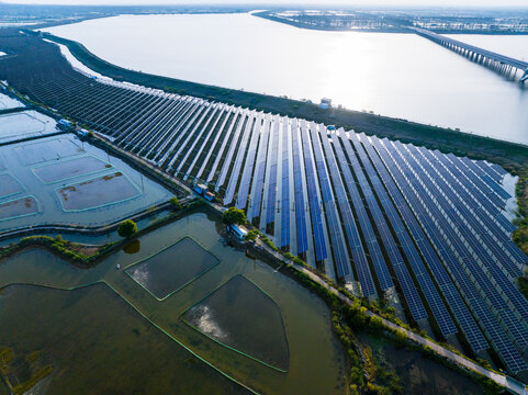 Aerial View of Large Solar Farm Beside Open Water