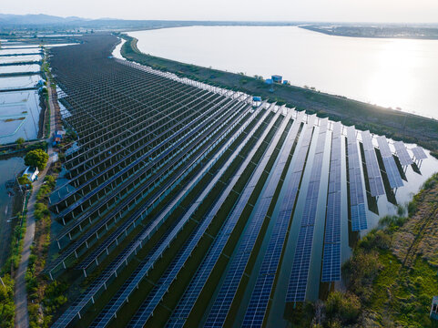 Aerial View of Large Solar Farm Beside Open Water