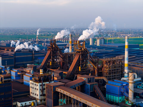 Aerial view of steel plant with blast furnaces and smoke stacks