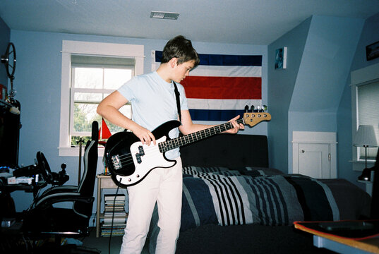 Portrait Teenager with electric bass Musician  bedroom 