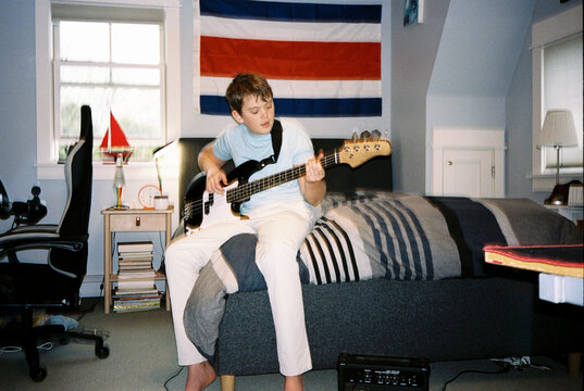 Film Portrait Teenager with electric bass Musician  bedroom 