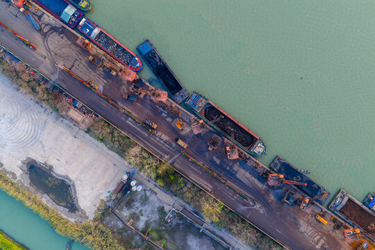 Aerial view of industrial port with cargo ships and factory complex