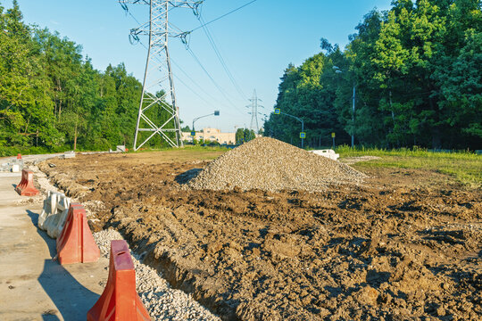 Rural road construction with gravel pile and power lines