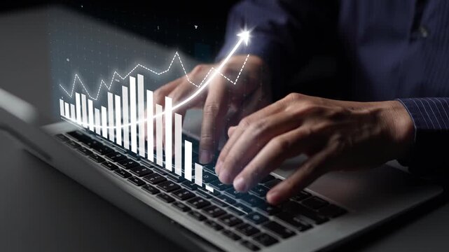 A professional workspace featuring hands typing on a laptop, complemented by digital graphics that illustrate financial growth and data analysis trends. Copula
