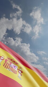 Passenger Airplane Flying Over Spanish Flag Against Blue Sky